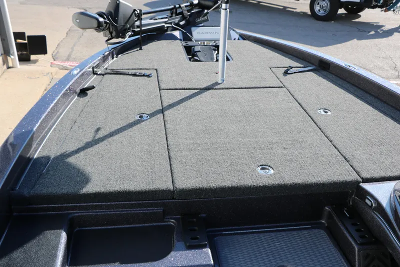 Slide: The Image of Front deck of 2027 Caymas 201 Pro boat with carpeted surface and storage compartments. - 21