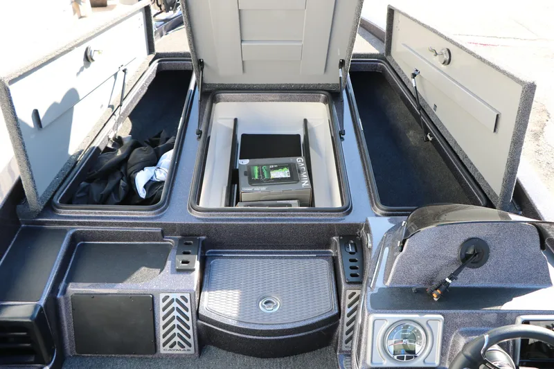 Slide: The Image of 2027 Caymas 201 Pro boat interior storage compartments with Garmin equipment. - 22
