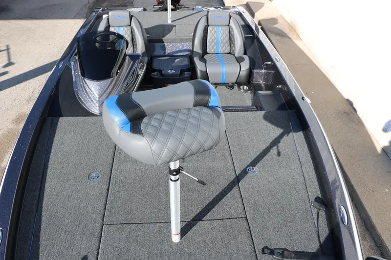 Slide: The Image of 2027 Caymas 201 Pro boat interior with gray and blue seating and spacious deck. - 24