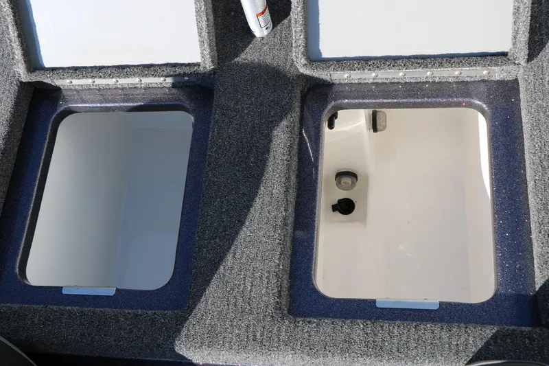 Slide: The Image of 2027 Caymas 201 Pro boat storage compartments with carpeted finish. - 29