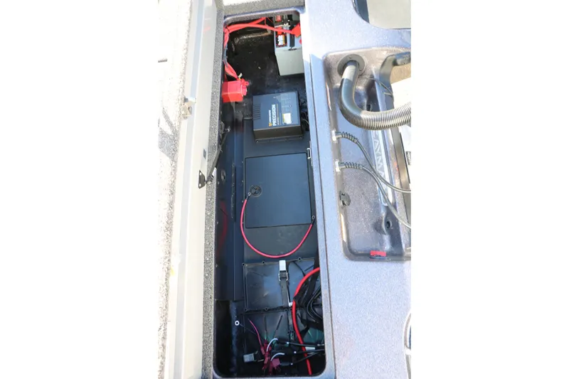 Slide: The Image of 2027 Caymas 201 Pro boat battery compartment with wiring and components. - 30