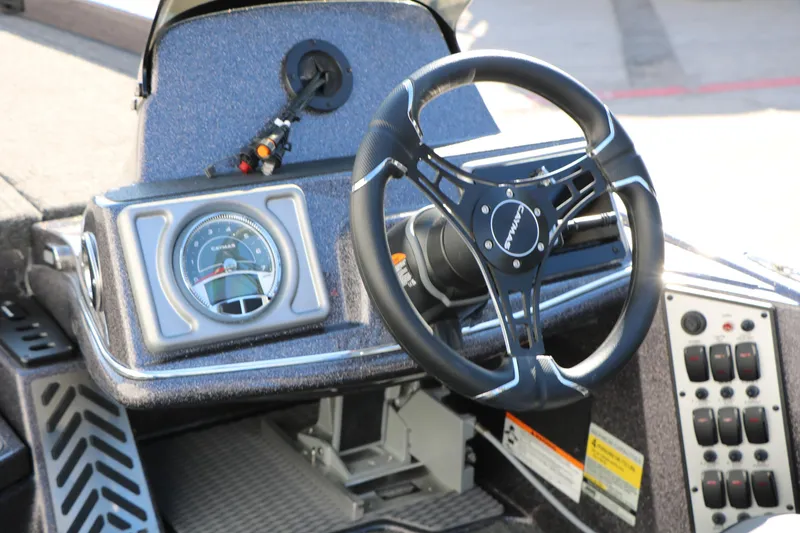 Slide: The Image of 2027 Caymas 201 Pro boat dashboard with steering wheel and control panel. - 32