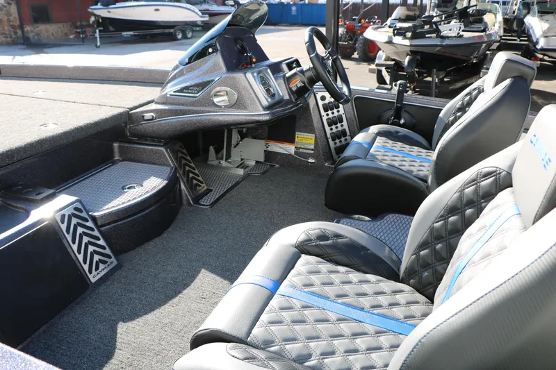 Slide: The Image of 2027 Caymas 201 Pro boat interior with modern dashboard and comfortable seating. - 9