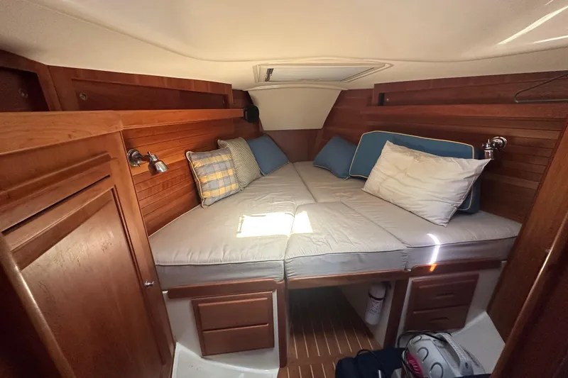 Slide: The Image of Cozy cabin interior of 1999 Beneteau Oceanis 352 sailboat with wooden finish and cushions. - 7