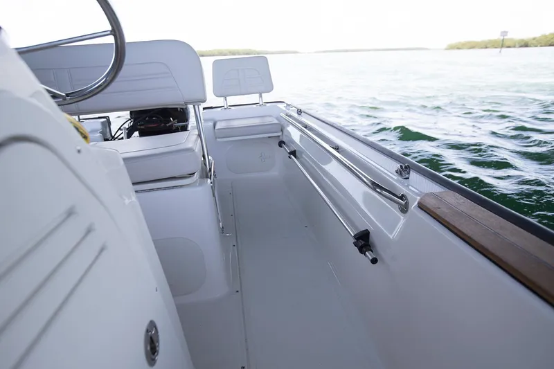 Slide: The Image of Manufacturer Provided Image: 2024 Boston Whaler 170 Montauk boat interior with seating and railing, on the water. - 21