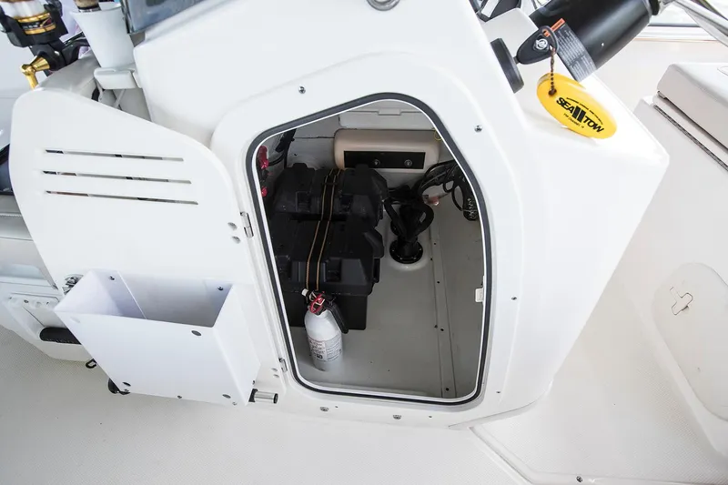 Slide: The Image of Manufacturer Provided Image: 2024 Boston Whaler 170 Montauk storage compartment with battery and fire extinguisher. - 27