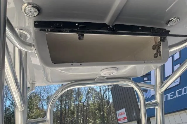 Slide: The Image of 2026 Key West 203 FS boat T-top storage compartment with stainless steel frame. - 11