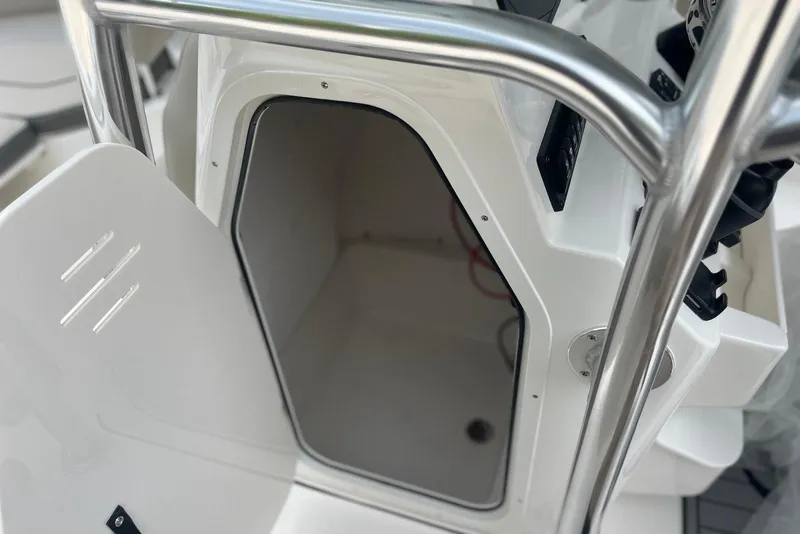 Slide: The Image of 2026 Key West 189 FS boat storage compartment with open door and stainless steel railing. - 20