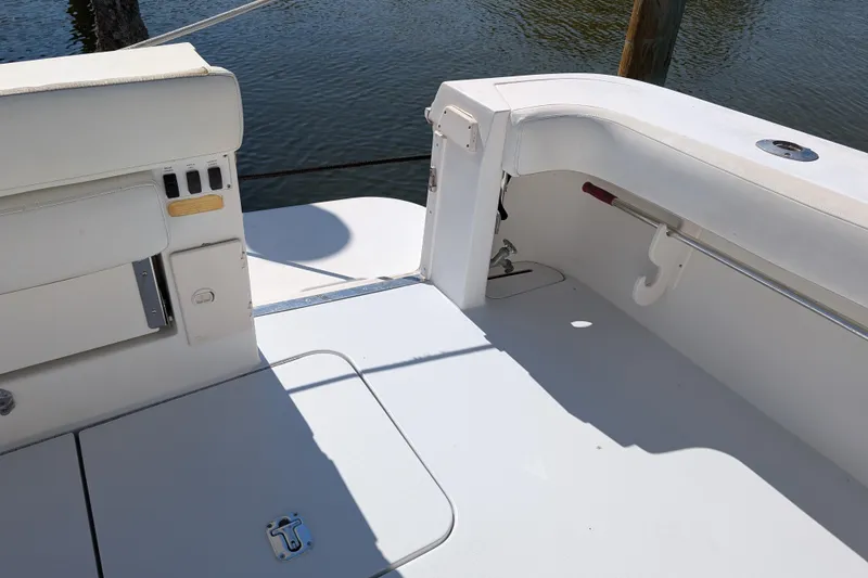 Slide: The Image of 1999 Sea Ray 370 Express Cruiser deck with white seating and water view. - 11