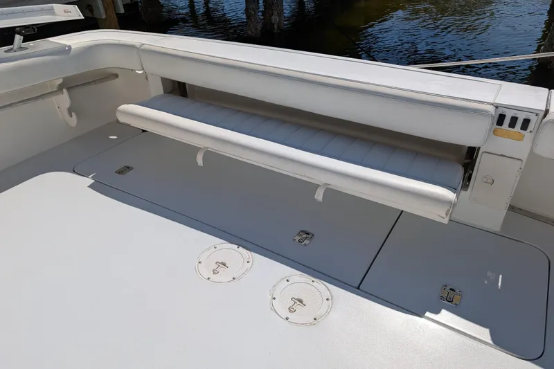 Slide: The Image of 1999 Sea Ray 370 Express Cruiser deck with fold-out bench seating. - 12