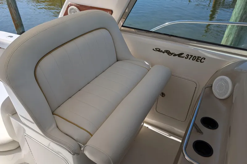 Slide: The Image of 1999 Sea Ray 370 Express Cruiser interior with white seating and logo detail. - 18