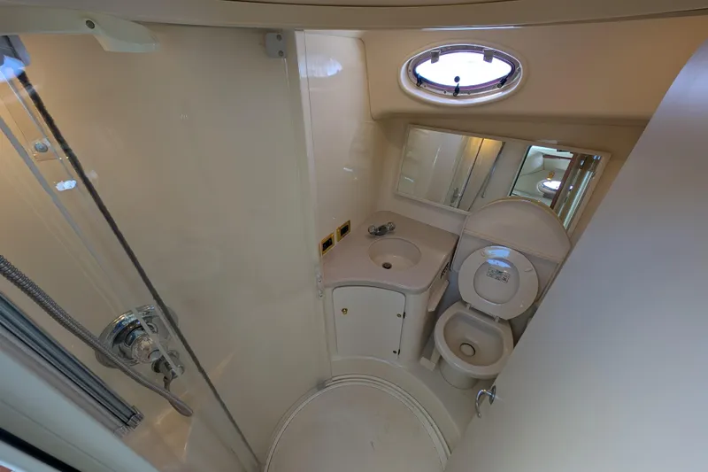 Slide: The Image of 1999 Sea Ray 370 Express Cruiser bathroom with shower, sink, and toilet. - 24