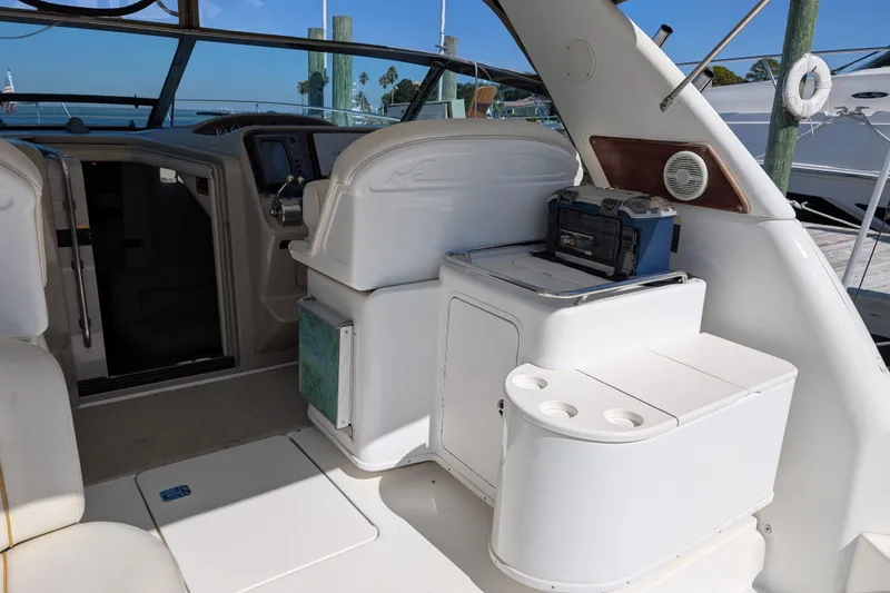 Slide: The Image of 1999 Sea Ray 370 Express Cruiser interior with helm, seating, and storage compartments. - 9
