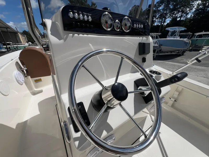 Slide: The Image of 2026 Pioneer 180 Islander boat steering console with gauges and controls. - 12