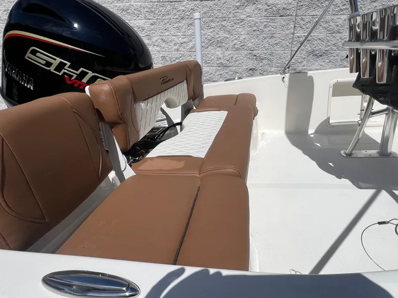 Slide: The Image of 2026 Pioneer 180 Islander boat interior with brown and white seating, Yamaha engine visible. - 3