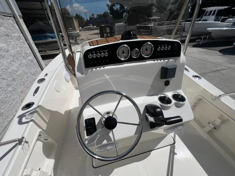 Slide: The Image of 2026 Pioneer 180 Islander boat dashboard with steering wheel and controls. - 7