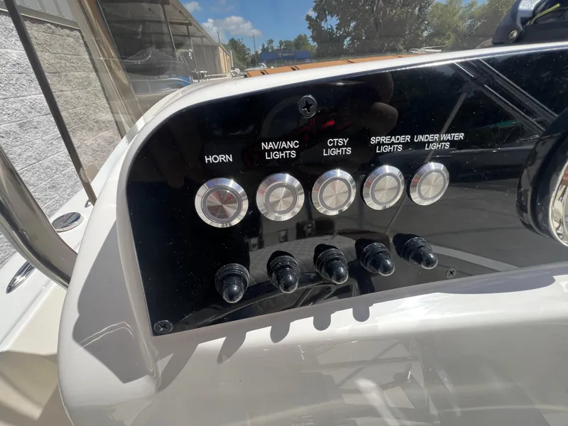 Slide: The Image of Control panel of 2026 Pioneer 180 Islander boat with various switches and buttons. - 8