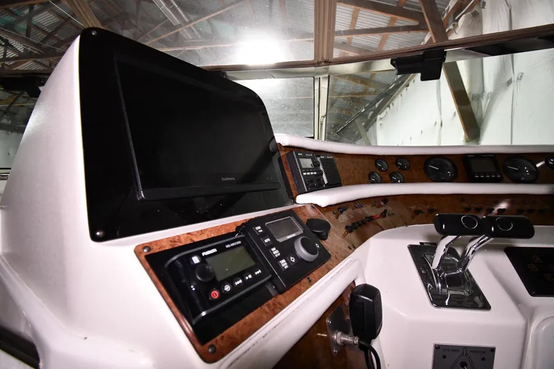 Slide: The Image of 1995 Sea Ray 440 Sundancer helm with navigation controls and instrument panel. - 10