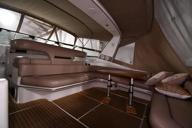 Slide: The Image of Luxurious interior of 1995 Sea Ray 440 Sundancer yacht with plush seating and wooden table. - 12