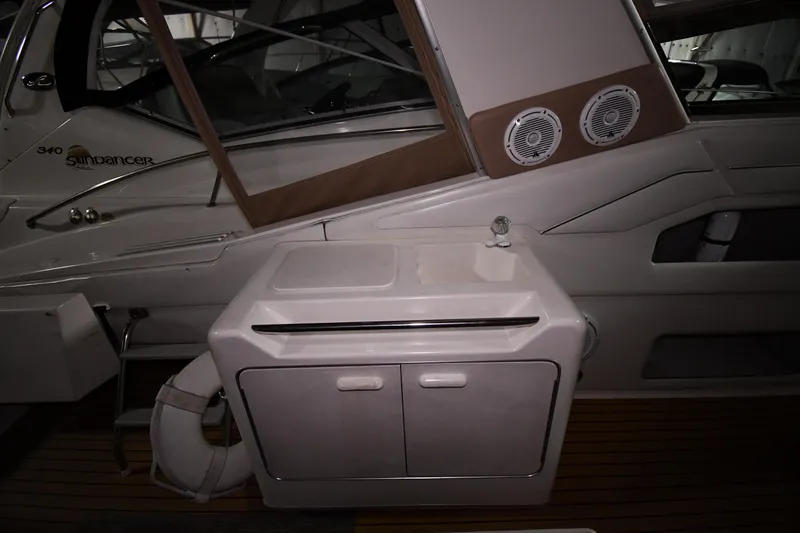 Slide: The Image of 1995 Sea Ray 440 Sundancer interior with sink and storage cabinet. - 17