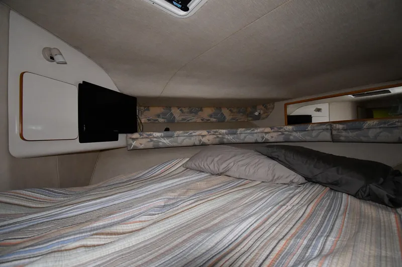 Slide: The Image of Interior cabin of 1995 Sea Ray 440 Sundancer with bed and TV. - 22