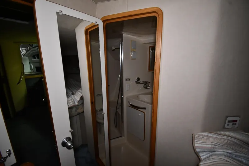 Slide: The Image of Interior of 1995 Sea Ray 440 Sundancer yacht showing bathroom and cabin area. - 25