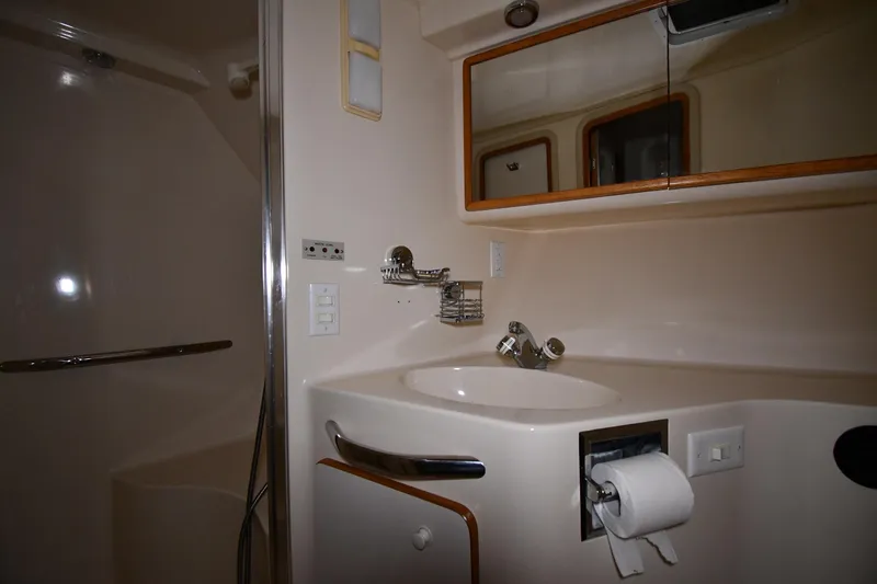 Slide: The Image of Bathroom interior of 1995 Sea Ray 440 Sundancer yacht, featuring sink and shower. - 26