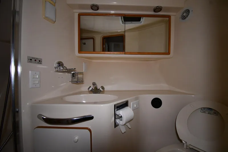 Slide: The Image of Bathroom interior of 1995 Sea Ray 440 Sundancer yacht, featuring sink and toilet. - 27