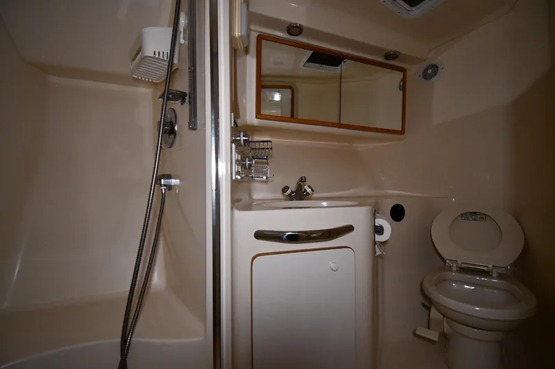 Slide: The Image of Bathroom interior of 1995 Sea Ray 440 Sundancer yacht, featuring shower and toilet. - 29