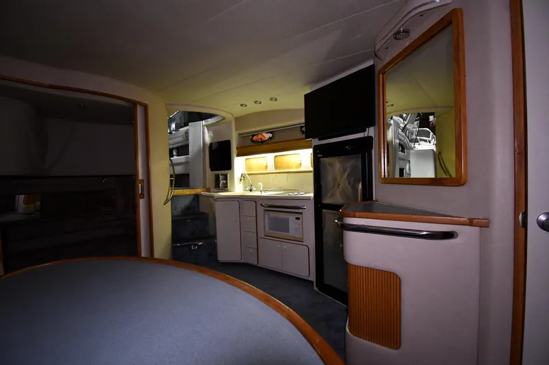 Slide: The Image of Interior of 1995 Sea Ray 440 Sundancer yacht with kitchenette and modern amenities. - 32