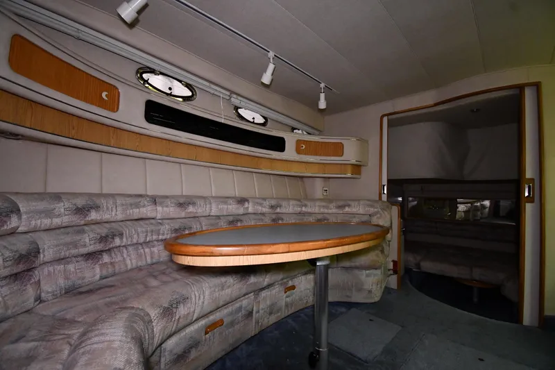 Slide: The Image of Interior of 1995 Sea Ray 440 Sundancer yacht with curved seating and table. - 33