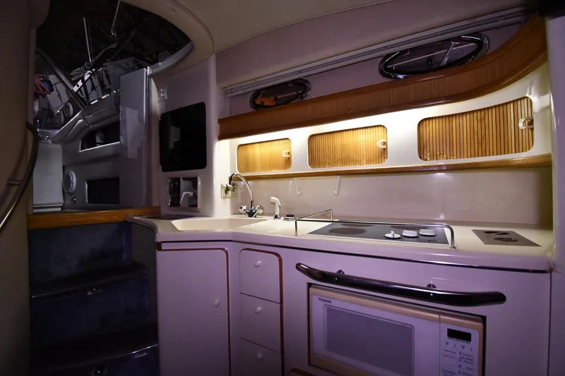 Slide: The Image of Interior of 1995 Sea Ray 440 Sundancer yacht kitchen with stove and microwave. - 34