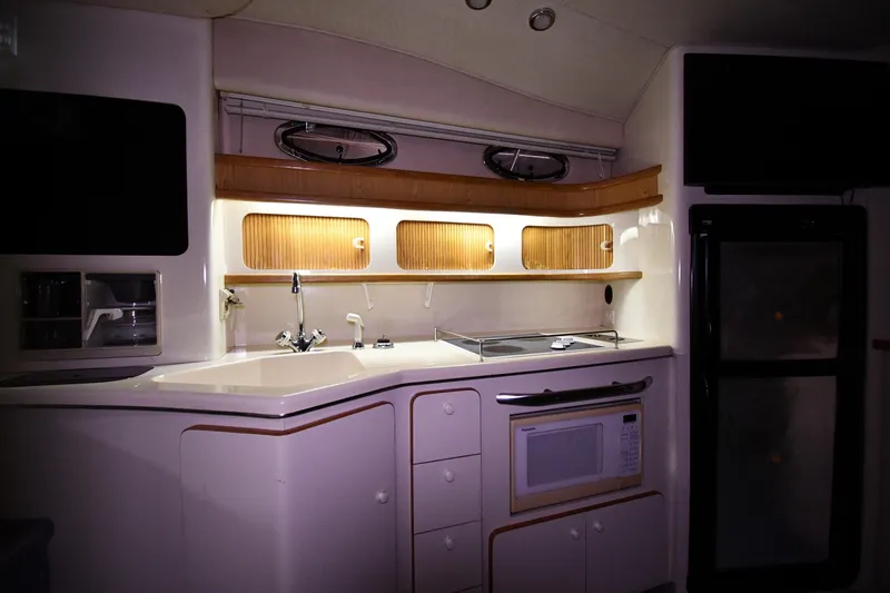 Slide: The Image of Interior of 1995 Sea Ray 440 Sundancer yacht kitchen with modern amenities. - 35