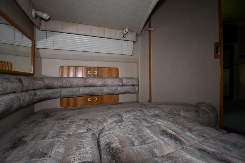 Slide: The Image of Interior cabin of 1995 Sea Ray 440 Sundancer with cushioned seating and wood accents. - 42