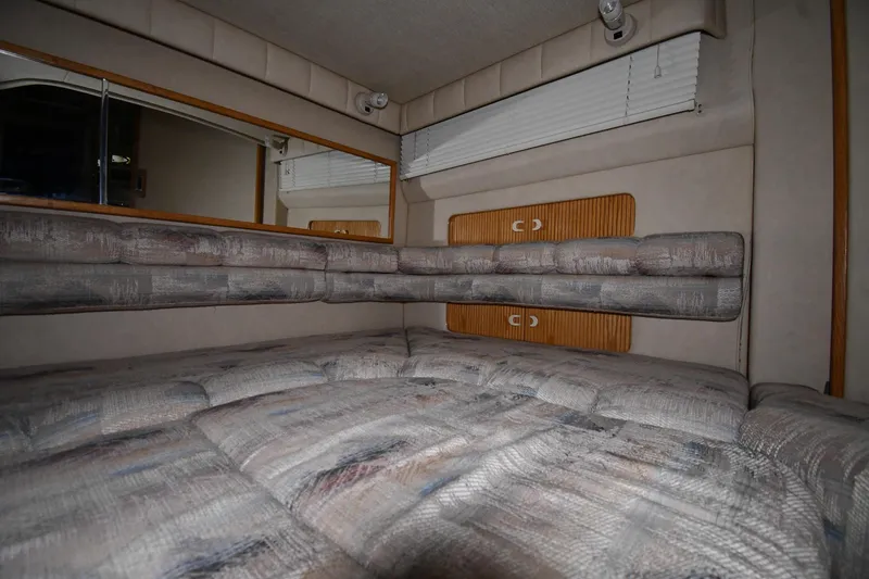 Slide: The Image of Interior cabin of 1995 Sea Ray 440 Sundancer with cushioned seating and wood accents. - 43