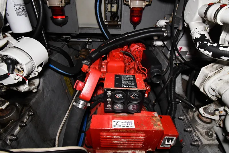 Slide: The Image of Engine room of a 1995 Sea Ray 440 Sundancer with visible components and wiring. - 49