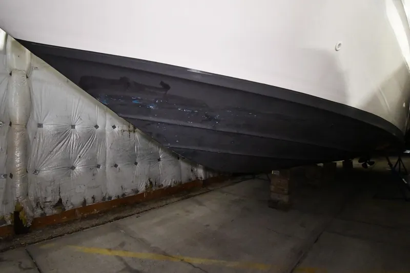 Slide: The Image of 1995 Sea Ray 440 Sundancer boat hull in storage, side view. - 52