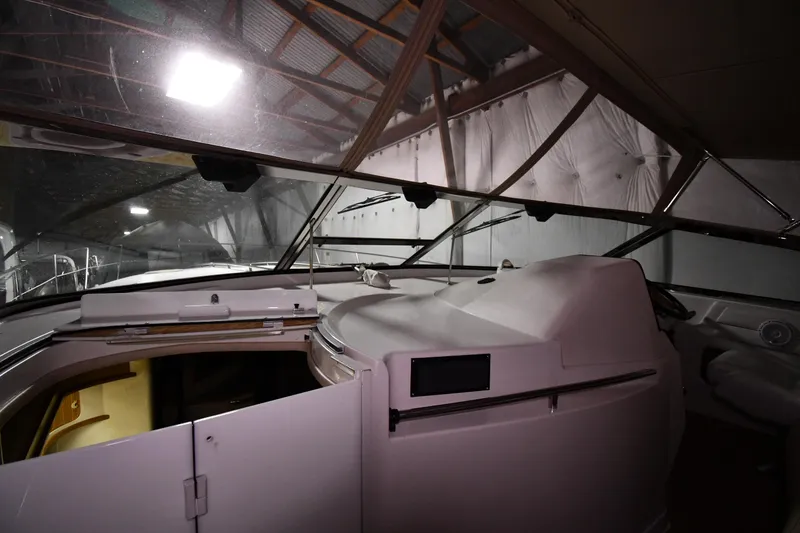 Slide: The Image of 1995 Sea Ray 440 Sundancer interior view in a dimly lit storage facility. - 8