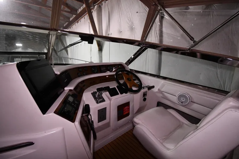 Slide: The Image of 1995 Sea Ray 440 Sundancer helm with steering wheel and control panel. - 9