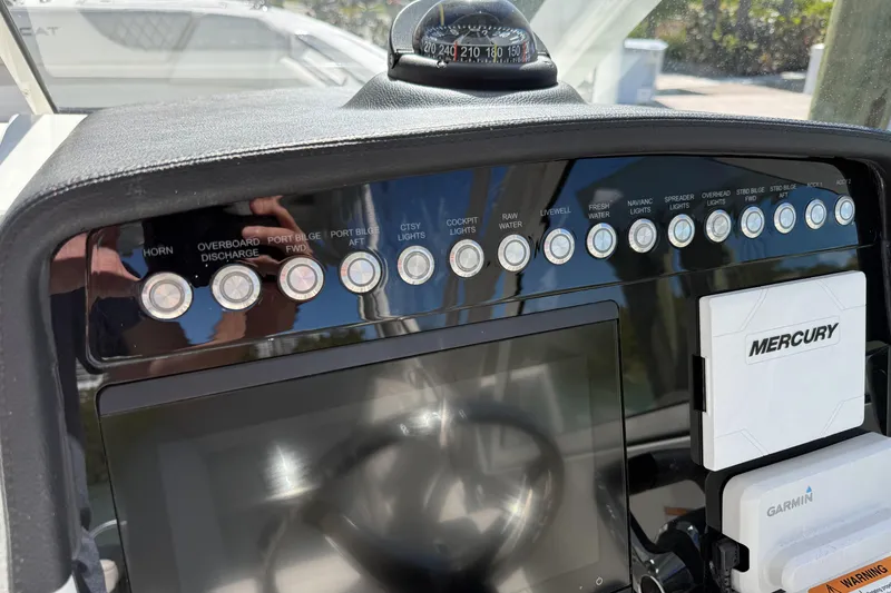 Slide: The Image of 2024 World Cat 296 DC dashboard with control buttons and navigation equipment. - 11