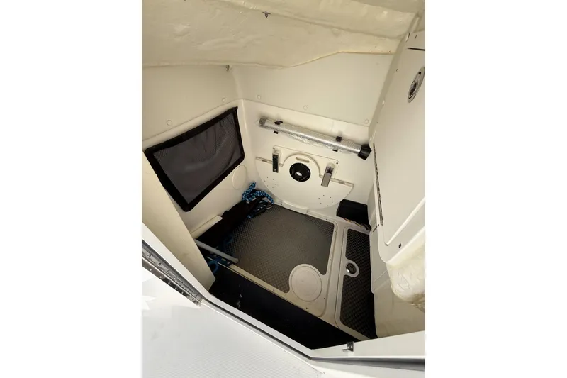 Slide: The Image of 2024 World Cat 296 DC interior storage compartment with organized equipment and netting. - 16