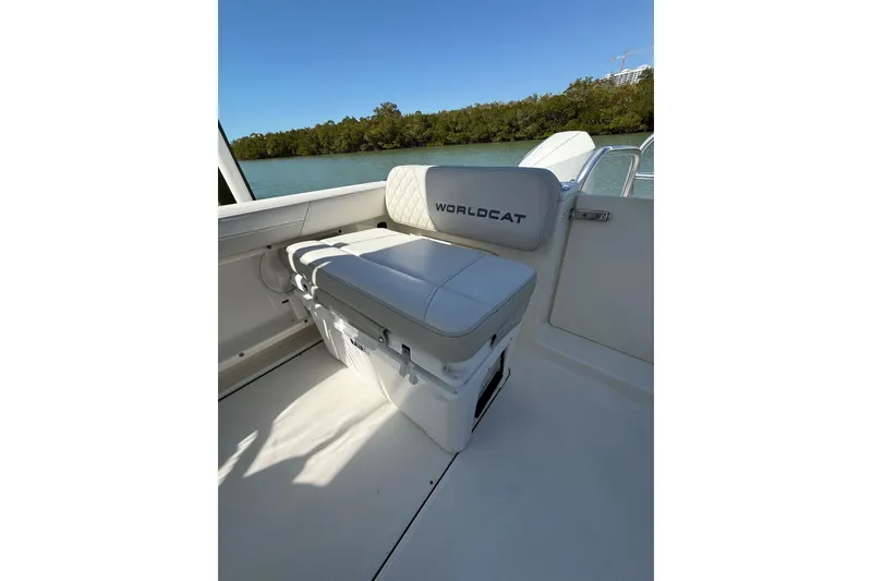 Slide: The Image of 2024 World Cat 296 DC boat interior with cushioned seating and scenic water view. - 3