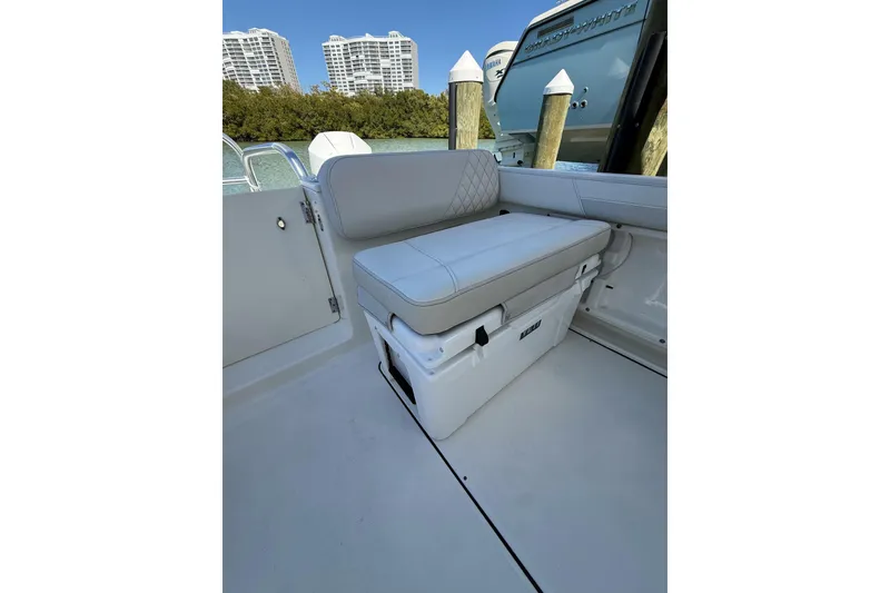 Slide: The Image of 2024 World Cat 296 DC boat interior with cushioned seating and storage. - 4