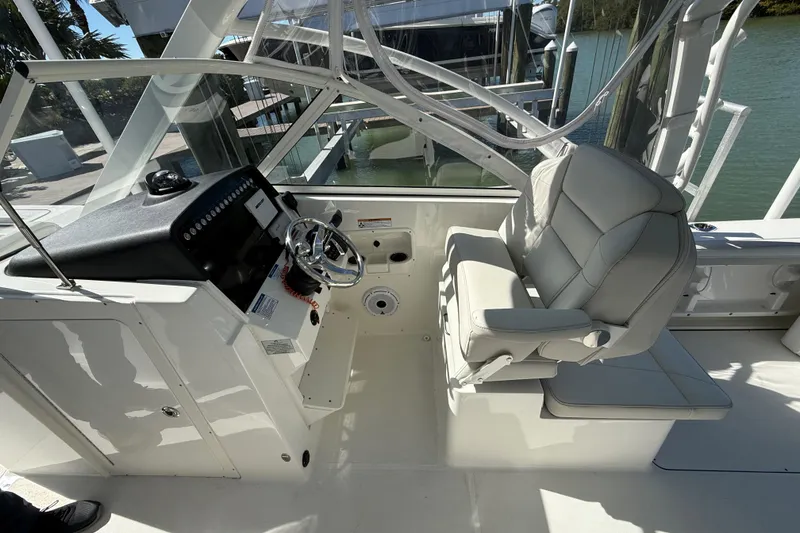Slide: The Image of 2024 World Cat 296 DC boat interior with helm and seating area. - 8