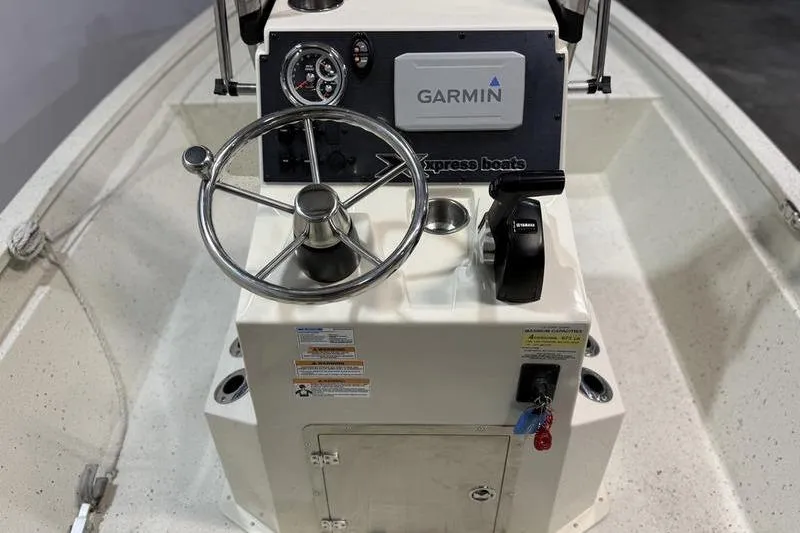 Slide: The Image of 2022 Express H190B boat console with Garmin navigation and steering wheel. - 10