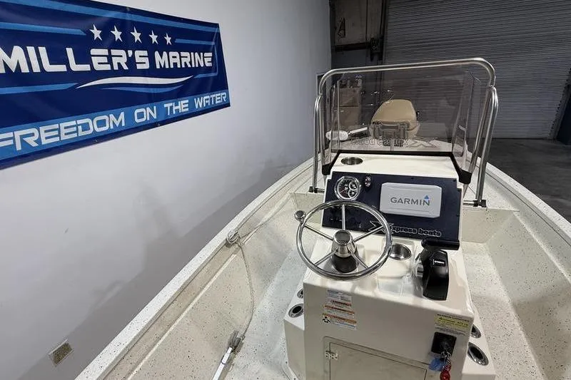 Slide: The Image of 2022 Express H190B boat interior with Garmin system at Miller's Marine showroom. - 11