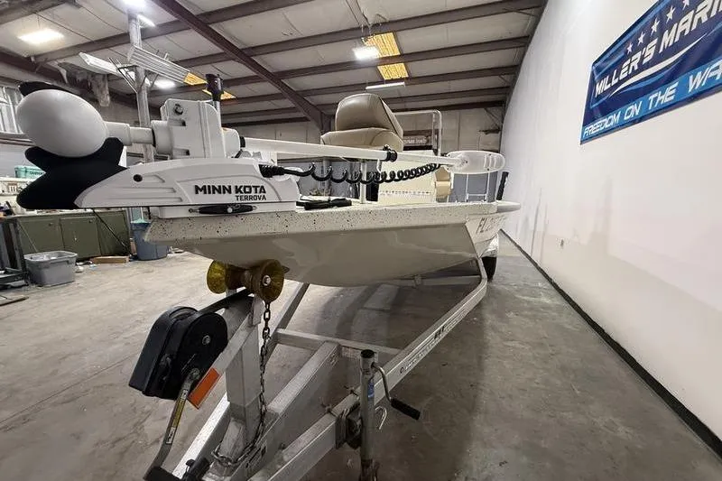 Slide: The Image of 2022 Express H190B boat with Minn Kota Terrova motor in a warehouse setting. - 2