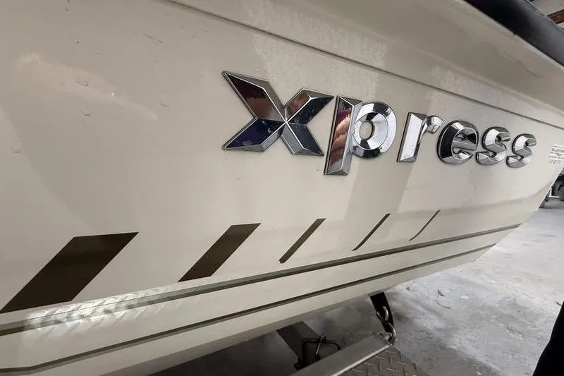 Slide: The Image of 2022 Express H190B boat with chrome logo and sleek design. - 5
