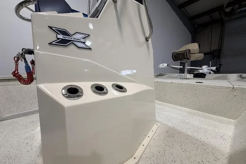 Slide: The Image of 2022 Express H190B boat interior with control panel and seating. - 9