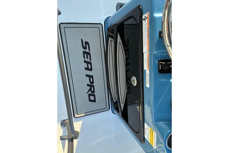 Slide: The Image of 2026 Sea Pro 250 Bay boat interior with logo and control panel. - 16